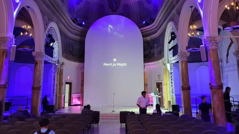 Next.js Night event stage in San Francisco with purple lighting