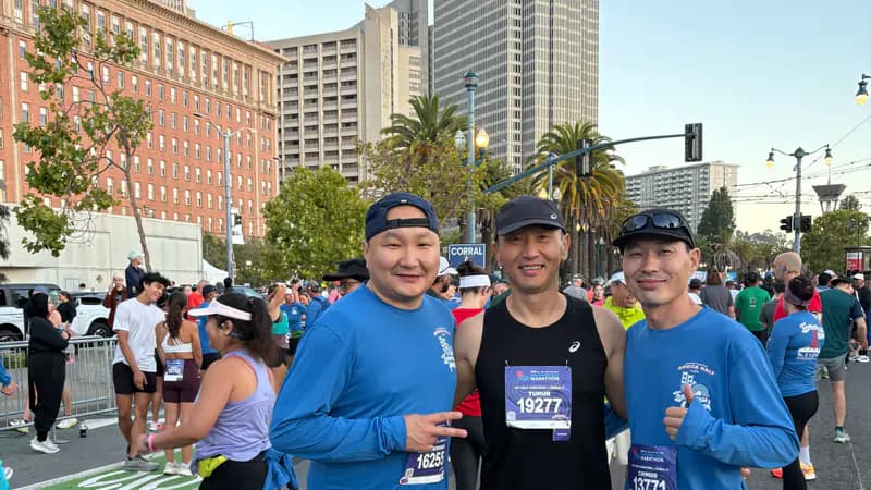 Tim with two running club friends before the 2026 San Francisco Half Marathon